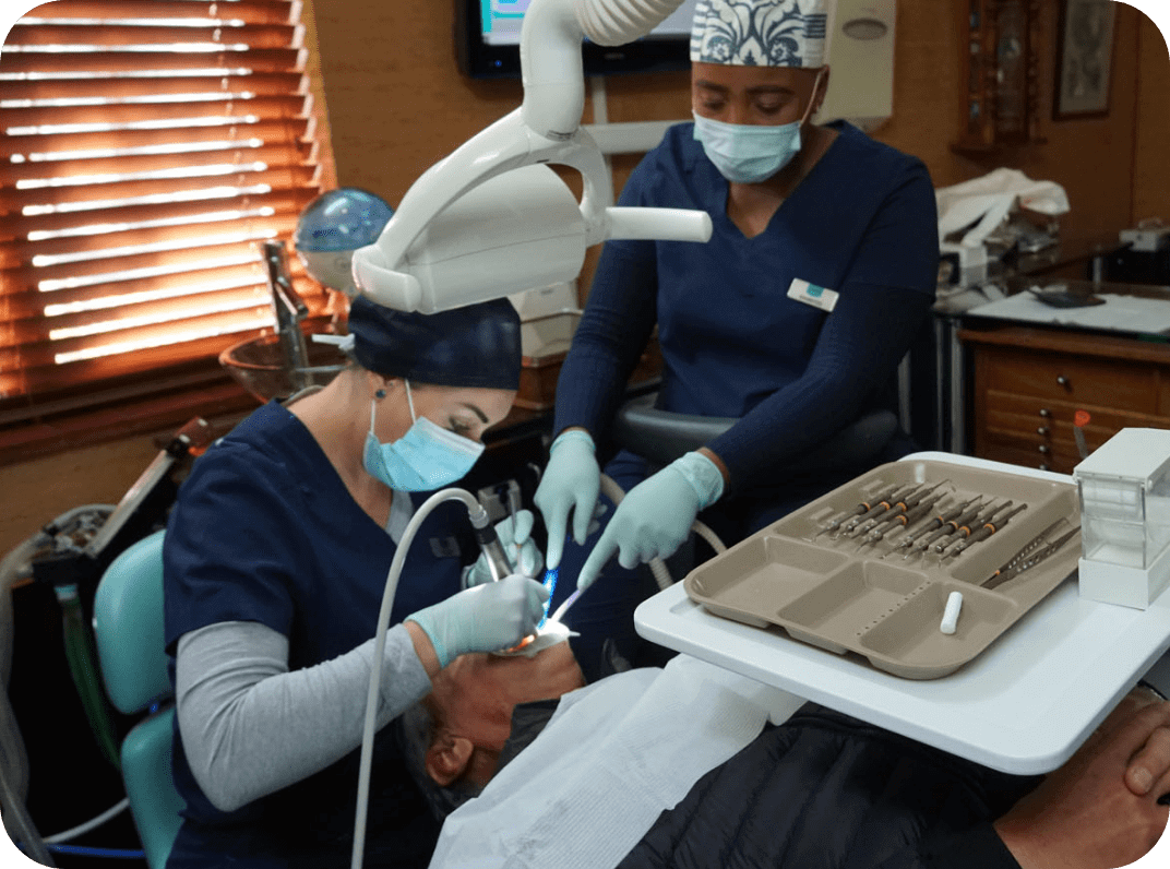Dentist and Assistant working on patient